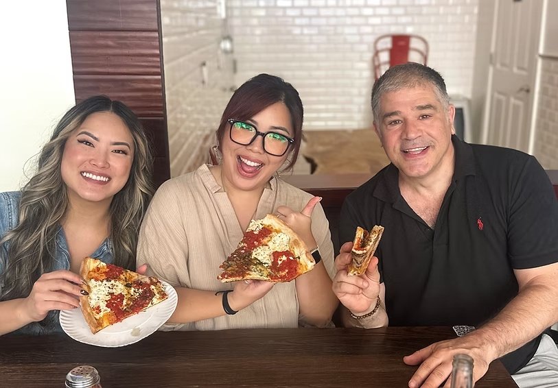 Tom sharing pizza and stories with food-tour guests